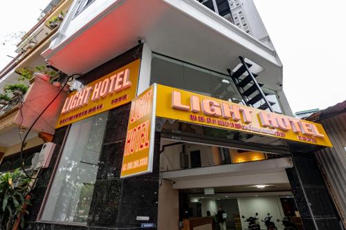 a light house with a sign in front of it at Light Hotel Ha Noi in Hanoi