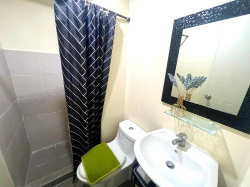 a bathroom with a white toilet and a sink at IT Park + fast net in Cebu City