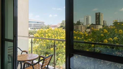 a view from a balcony with a table and chairs at Lotos Inn & Suites, Nairobi in Nairobi