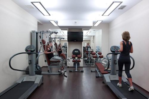 a woman is working out in a gym at Grand Hotel Continental Bucuresti in Bucharest