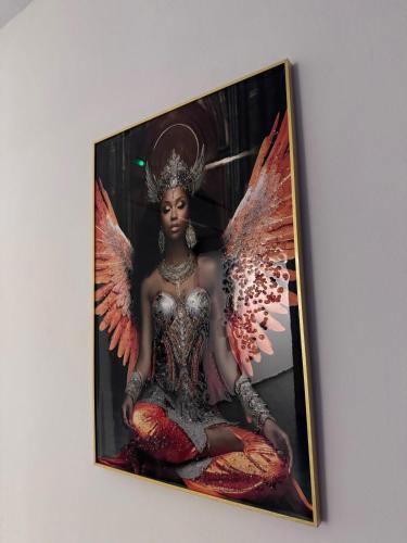 a picture of an angel statue on a wall at Le silver appartement 2 chambres in Libreville