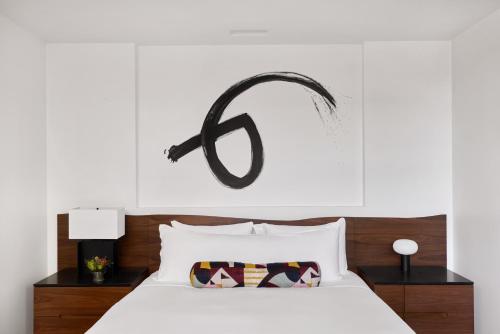 a bedroom with a bed with a peace sign above it at Bardessono Hotel and Spa in Yountville