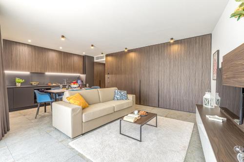 a living room with a couch and a table at ICON H Lugano - Luxury Suites & Apartments in Lugano