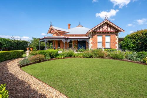 a house with a large lawn in front of it at Luxury at Lauralla - An Elegant Victorian Escape in Mudgee