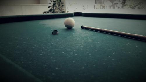 a snooker ball and a bat on a pool table at Poseidonio in Piraeus