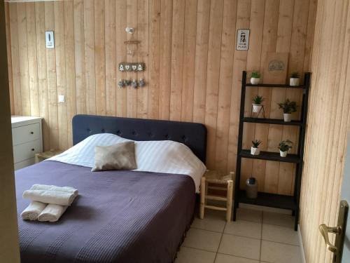 une chambre avec un lit bleu avec des serviettes dessus dans l'établissement L’étoile de mer , maison en plein centre ville, à Bretignolles-sur-Mer