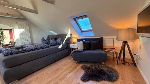 a living room with a couch and a chair at Ysenberc Apartments in Moritzburg