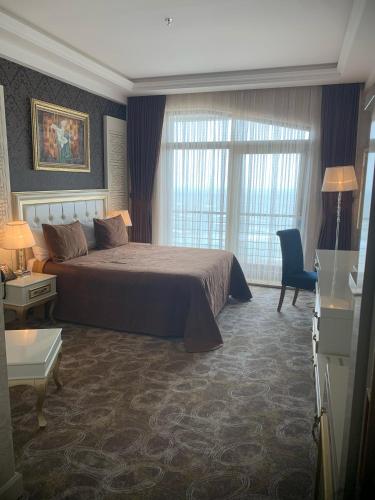 a hotel room with a bed and a window at Khazri in Baku