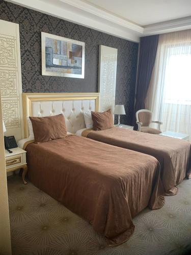 a hotel room with two beds and a window at Khazri in Baku