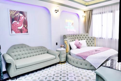 a bedroom with a couch and a bed and a chair at New Pearl Hotel in Ho Chi Minh City