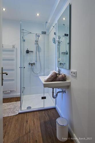 a bathroom with a shower and a sink at Hotel aanders in Neumünster