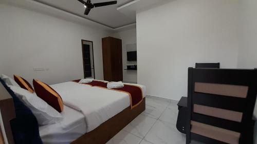 a bedroom with a bed in a room at RKM Pearl Residency in Cochin