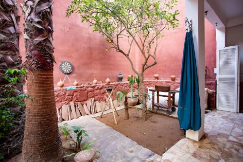 a patio with a table and an umbrella and trees at Charming 5 bedroom in Marrakech