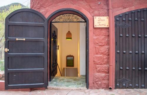 an entrance to a red building with two black doors at Charming 5 bedroom in Marrakech