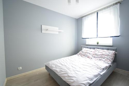 a small bedroom with a bed and a window at Madrycka in Gorzów Wielkopolski