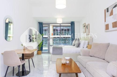 a living room with a white couch and a table at Bloomfields Pretty Stu in Oasis in Abu Dhabi Intl