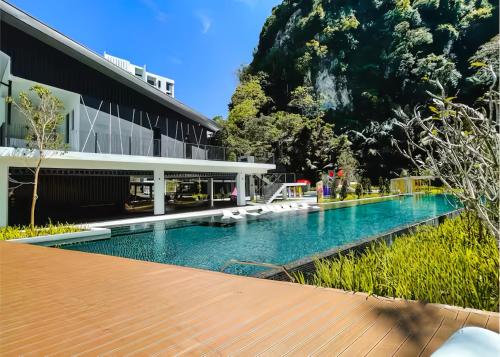 a swimming pool in front of a building at The Cove Hillside Residence Ipoh in Ipoh