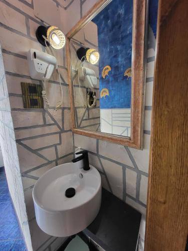 a bathroom with a white sink and a mirror at Dimora in San Quirico d'Orcia in San Quirico dʼOrcia