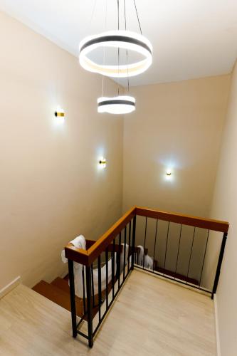 a room with a staircase with a chandelier at Duke Oasis in Kuala Lumpur
