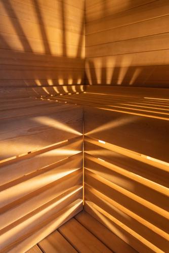 a wooden ceiling in a sauna with its shadows on the floor at Palazzo Arco Cadura Hotel & Spa in Galatina