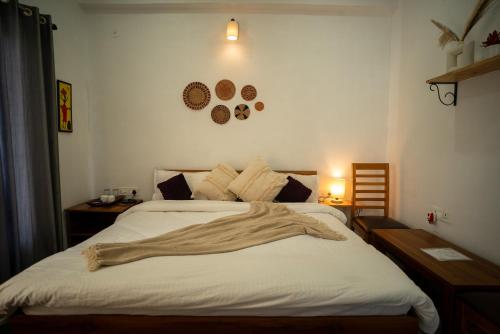 a bedroom with a bed with a blanket on it at Hidden Lake By Vista Stays in Bhīm Tāl