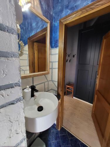 a bathroom with a white sink and a mirror at Dimora in San Quirico d'Orcia in San Quirico dʼOrcia