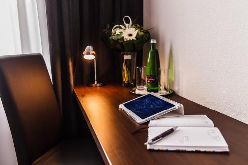 a desk with a pen and a tablet on it at Interhotel Zlín in Zlín