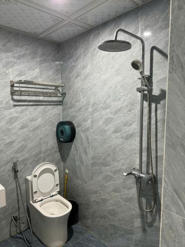 a bathroom with a shower with a toilet and a shower at NH Hotel in Hanoi
