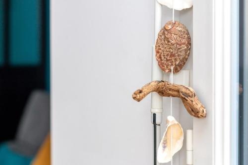 an owl ornament and seashells hanging on a door at Beautiful 2 bedroom in Palaiseau Ideal for professionals in Palaiseau