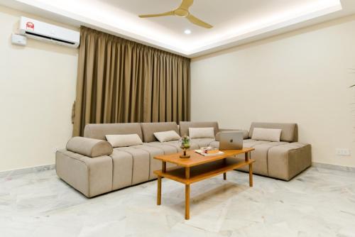 a living room with two couches and a table at Duke Oasis in Kuala Lumpur
