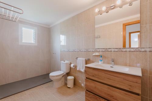 a bathroom with a toilet and a sink and a mirror at Laguito in Alcudia