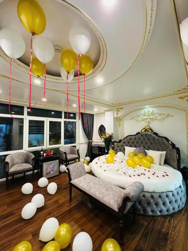 a bedroom with a bed with balloons hanging from the ceiling at Aloha Hotel in Hanoi