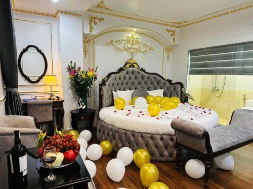 a bedroom with a bed with balloons on the floor at Aloha Hotel in Hanoi
