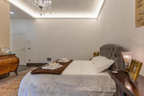 a bedroom with a bed with a tray of food on it at Dimora D'Incanto in Ragusa
