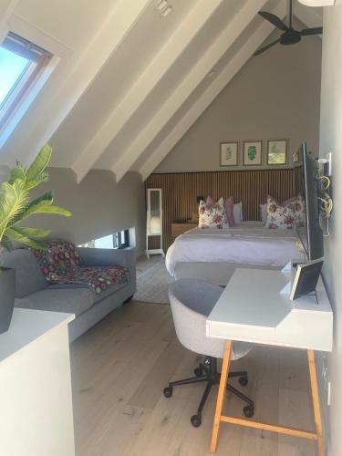 a bedroom with a bed and a couch at Endless Summer in St Francis Bay