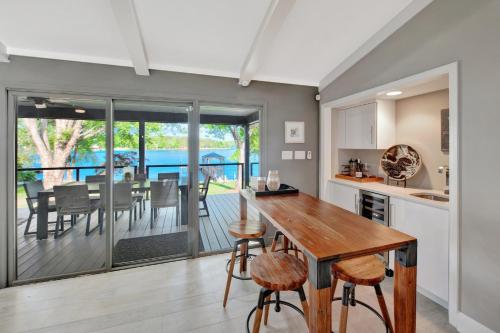 a kitchen and dining room with a table and chairs at Southern Sunrise Covered Dock & Optional Boat Rental in Mooresville