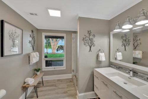 a bathroom with a sink and a mirror at Southern Sunrise Covered Dock & Optional Boat Rental in Mooresville