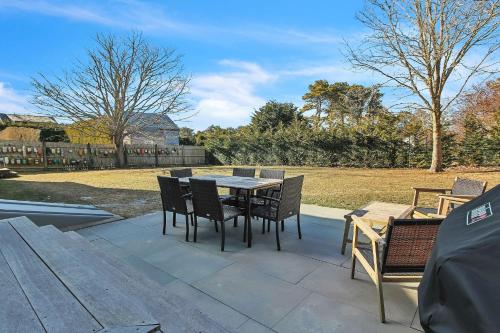 a table and chairs sitting on a patio at Charming 3BR Home in Nantucket's Natural Beauty home in Nantucket