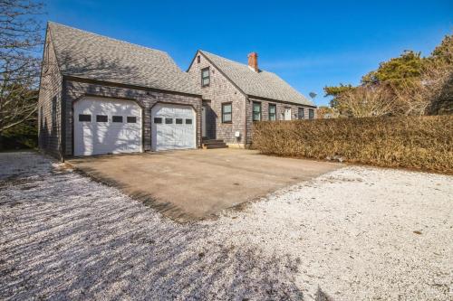 a house with two garage doors on a driveway at Charming 3BR Home in Nantucket's Natural Beauty home in Nantucket