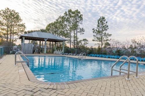 a large swimming pool with a gazebo next to at The Rookery III 5008 cottage in Gulf Shores