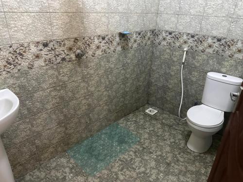 a bathroom with a toilet and a sink at Bee Luxury homes 3bedroom apartment in Nairobi