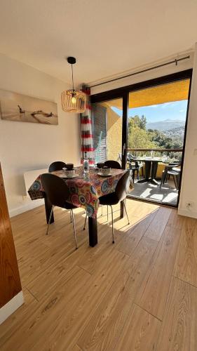 - un salon avec une table et des chaises offrant une vue dans l'établissement Porticcio Appartement T2 Résidence Terra Bella 1, proche plage & commerces, à Grosseto-Prugna