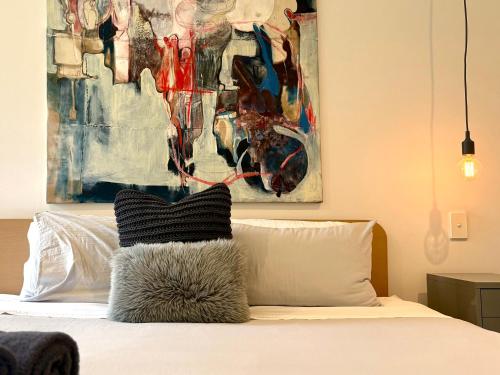 a bedroom with a bed with a painting on the wall at The Bowden Hideaway I City Fringe I Sleeps 10 I Free Parking I Walk to Cafe's in Bowden