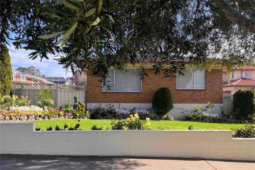 a house with a garden in front of it at Best on the Block minimum four nights in Auckland