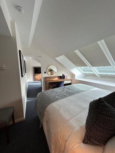 a bedroom with a bed and a desk in it at Radisson Blu Hotel, Durham in Durham