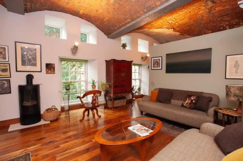 a living room with a couch and a table at Unique House in Park District in Glasgow