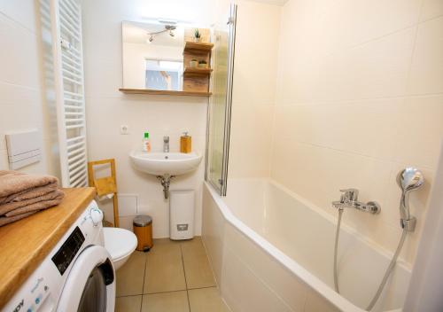 a bathroom with a toilet and a sink and a shower at FeWo 02 Maisonette im Carre`Charlott in Pulsnitz