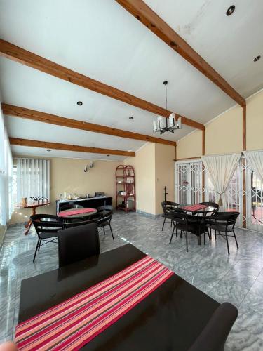 a living room with tables and a pool table at Zinzanathi Guest house in Ladysmith