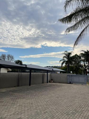 a roof of a building with a fence and palm trees at Zinzanathi Guest house in Ladysmith