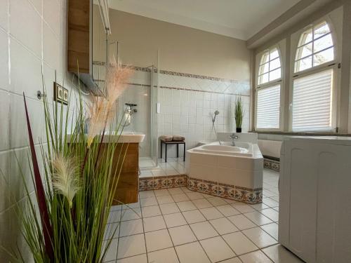 a bathroom with a tub and a sink at Wohnperle*GroßerGarten*Villa in Dresden